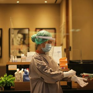 person in white dress shirt wearing green and white hat
